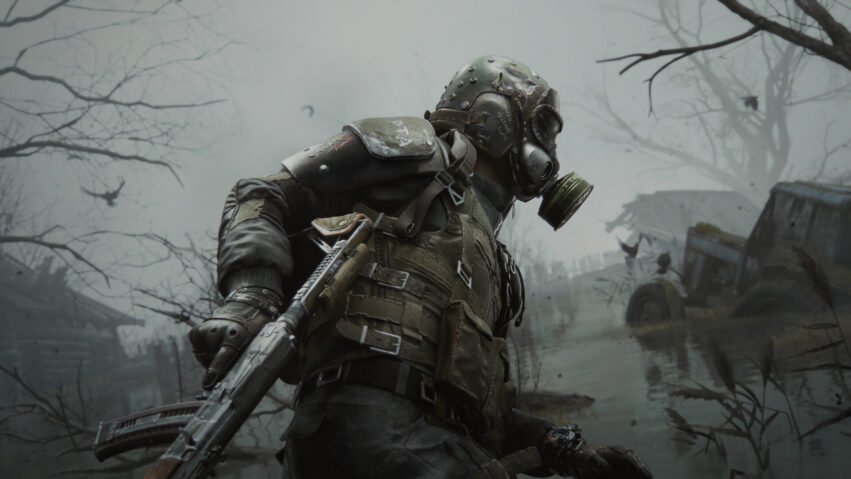 Soldier wearing a gas mask and tactical gear in a foggy, ruined battlefield with wrecked vehicles nearby, crouching with rifle ready.