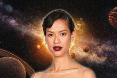Portrait of a woman with short dark hair and bold lipstick, set against a cosmic space scene with planets and a glowing background.