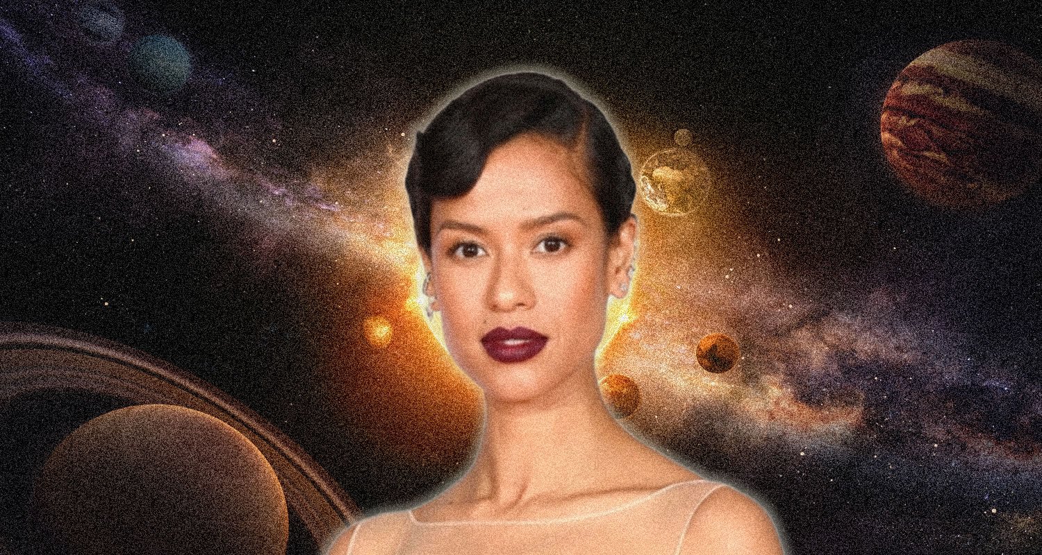 Portrait of a woman with short dark hair and bold lipstick, set against a cosmic space scene with planets and a glowing background.