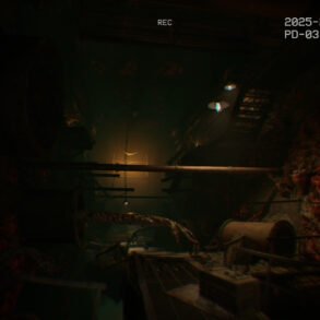 Dim, underground industrial tunnel with rusty pipes, exposed cables, and red-tinged rock walls lit by a faint glow.