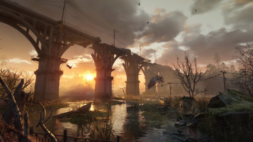 Sunset over a destroyed elevated bridge with broken arches spanning a swampy river, wrecked car, and bare trees.