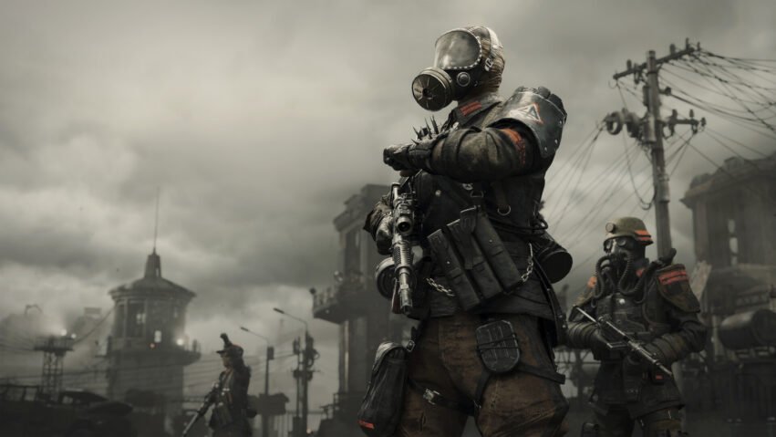 Dusty post-apocalyptic soldiers in gas masks guard a ruined city, rifles drawn.