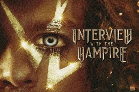 Close-up of a woman's face with gold face paint and a blue eye, advertising the poster for 'Interview with the Vampire'.