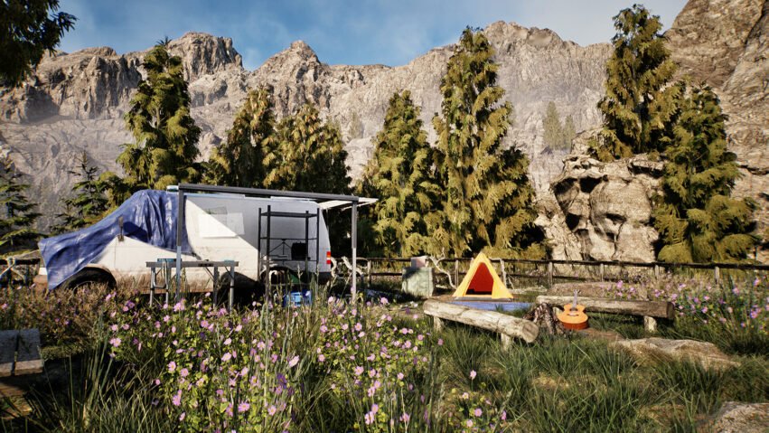 Camping trailer with blue tarp, parked near wildflowers and pine trees against rocky mountains backdrop.