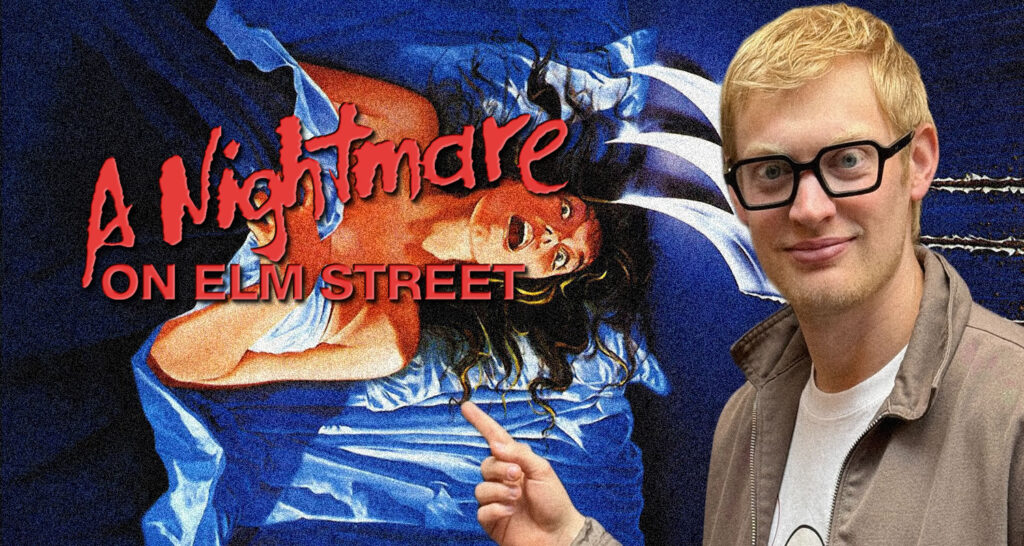 Young man with blond hair and glasses posing beside a 'A Nightmare on Elm Street' poster, which shows a screaming woman in blue.