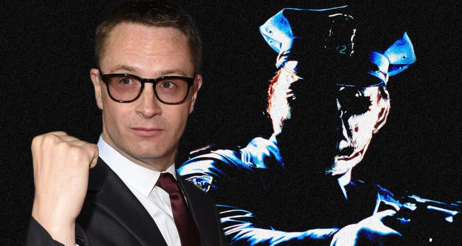 Man in a dark suit and glasses with a raised fist next to a large blue-toned graphic of a police officer