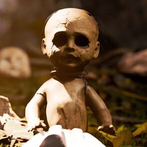 Cracked baby doll sitting on fallen leaves in a dim yard, with another doll blurred in the background.