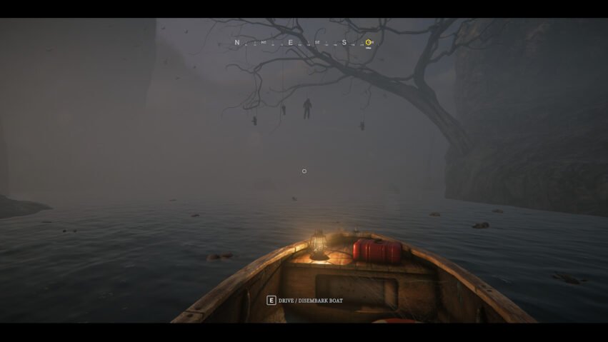In-game view from a small boat on a foggy river, with a glowing lantern and a spooky tree with hanging figures in the distance.