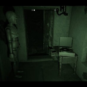 Dimly lit green room with a mannequin standing by a doorway and a vinyl record player on a small table; open dark corridor beyond the door.