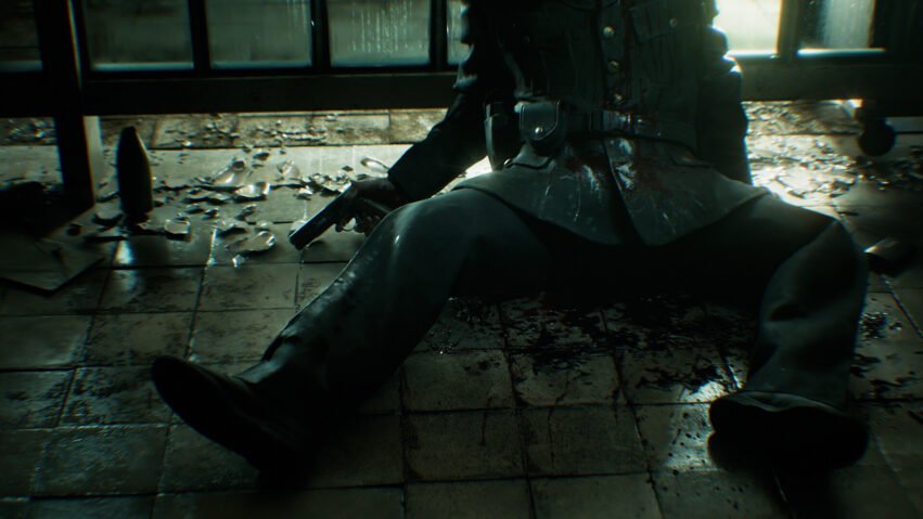 Person in dark clothing sits on a bloodstained tiled floor, a handgun in hand and shattered glass scattered around a dim room.