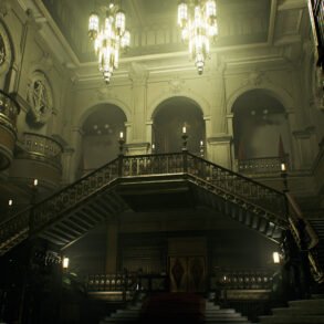 Grand, ornate interior with a sweeping central staircase, iron railings, arches, and hanging chandeliers in a historic library hall.