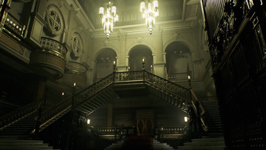 Grand, ornate interior with a sweeping central staircase, iron railings, arches, and hanging chandeliers in a historic library hall.