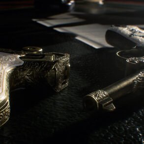 Close-up of ornate engraved pistols with silver and mother-of-pearl grips on a dark surface.