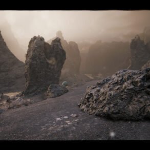 Rugged volcanic landscape with jagged rock formations and a small green ball resting on gravel foreground.