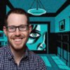 Smiling man with glasses in front of a teal-and-black mural featuring a large eye and architectural panels.