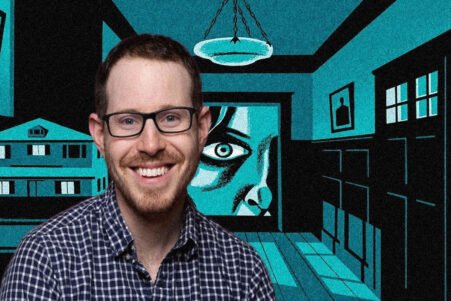 Smiling man with glasses in front of a teal-and-black mural featuring a large eye and architectural panels.